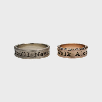 White and rose gold wedding rings with gemstones and the engraving You’ll never walk alone, by RINGKING Max Grün