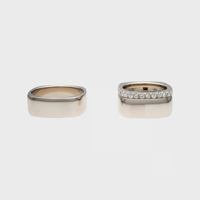Squared white gold wedding rings with pavé-set gemstones, pair lying flat, by RINGKING Max Grün