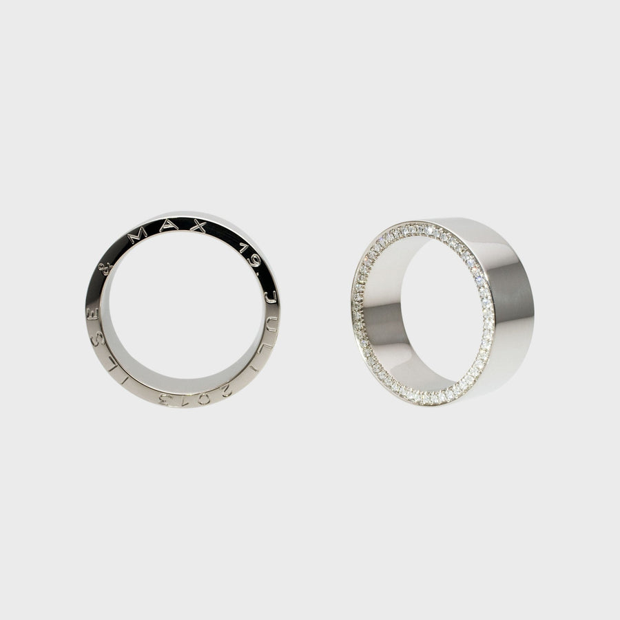 Wedding rings with side-set micro-pavé gemstones, pair standing upright, by RINGKING Max Grün